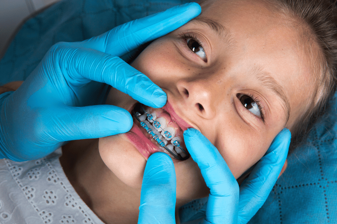orthodontist evaluating a patient’s teeth for oral health care
