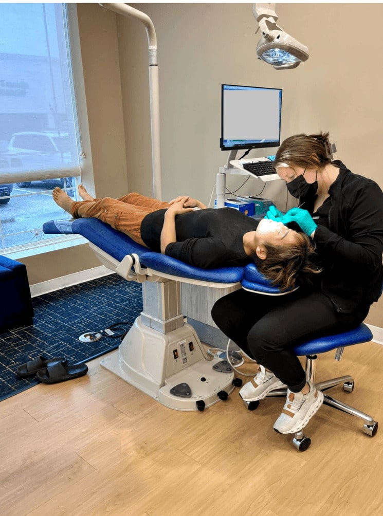 Patient undergoing orthodontic treatment at Smiles By Design